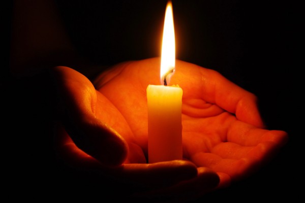 burning candle isolated on black background